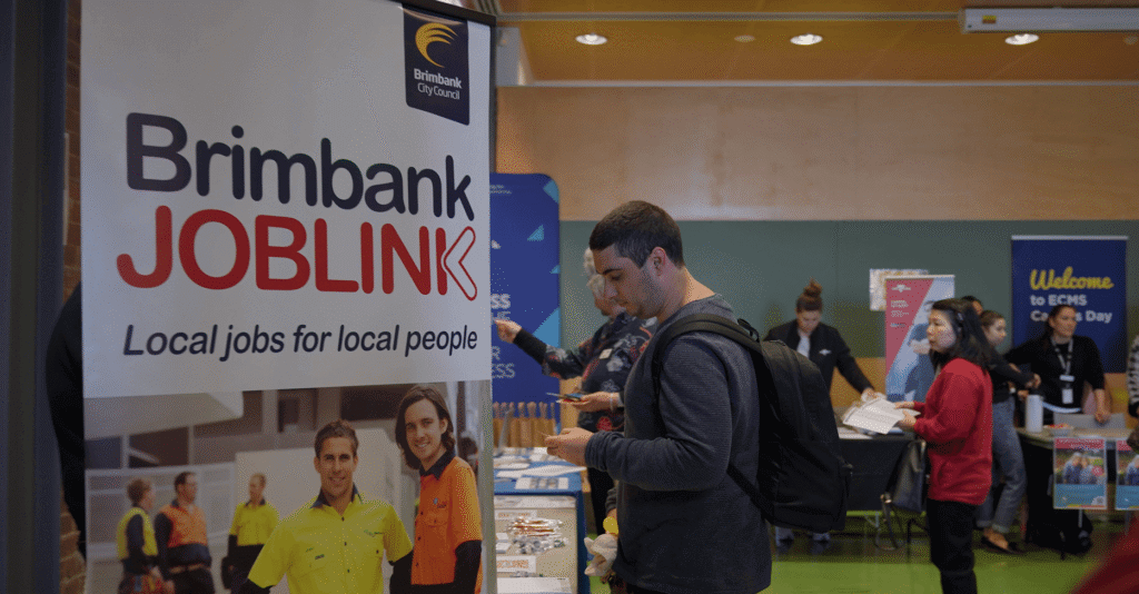 People roaming the Brimbank Local Jobs Showcase with the Brimbank Joblink banner in the foreground