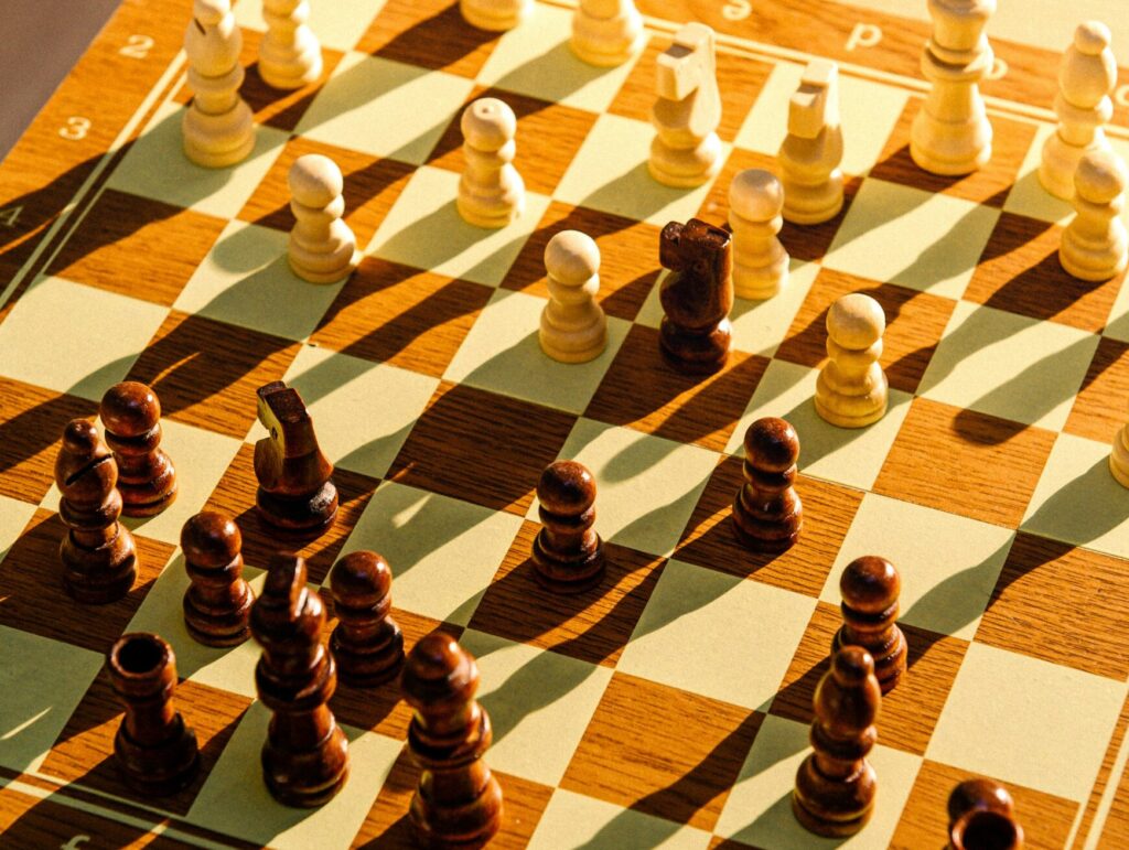 a close up of chess pieces on a chess board