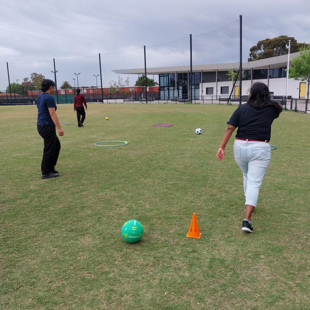 Two people walk around an oval
